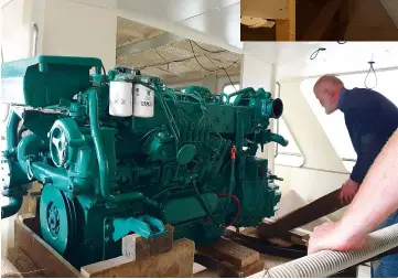  ??  ?? BELOW: Bill helps lower the trusty shaftdrive Volvo Penta TAMD 61 into the engineroom