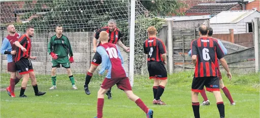  ??  ?? ●●Action from Stoconians clash against Whalley Range A (in red and black)