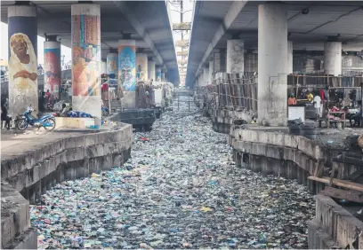  ?? Picture: AFP ?? CLOGGED. A canal filled with styrofoam and single use plastic at Obalende in Lagos, Nigeria.