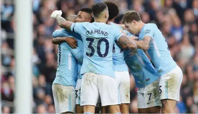  ??  ?? Gabriel Jesus is mobbed after scoring Man City’s third goal