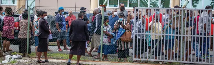  ?? Photo: Leon Lord ?? Sureties and family member of the alleged Nabua brawlers waiting outside the Fiji Police Force Academy in Nasova, Suva on October 11, 2021.