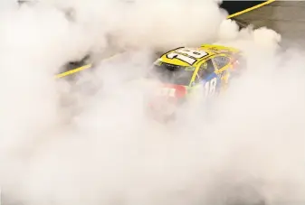  ?? Robert Laberge / Getty Images ?? Kyle Busch celebrates with a burnout after winning the NASCAR Cup Series playoff race at Richmond (Va.) Raceway, where he has won six times in his career.