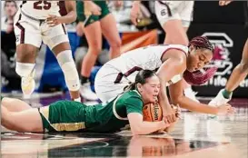  ?? Sean Rayford / Associated Press ?? South Carolina’s Aliyah Boston, top, and South Florida’s Aerial Wilson battle for the ball during the top-seeded Gamecocks’ 76-45 win Sunday. South Carolina will next face either UCLA or Oklahoma in the Sweet 16.