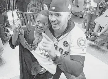  ?? Karen Warren / Houston Chronicle ?? Astros star Carlos Correa visits with 5-year-old Isaiah Wilkins, who had heart surgery a day earlier. Correa and his fiancée, Daniella Rodriguez, visited patients at Children’s Memorial Hermann Hospital on Tuesday.