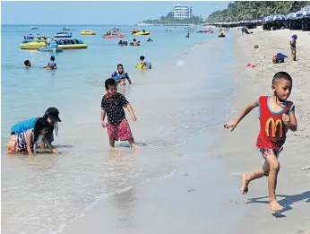  ??  ?? CHILD’S PLAY: Mr Narongchai hopes more families will visit the beach following his clean-up drive.