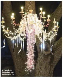  ?? LUIS SANTANA Tampa Bay Times/TNS ?? A chandelier hangs in a yard in Dunedin, Fla.