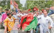  ??  ?? Samajwadi Party workers celebrate their party’s success in Uttar Pradesh