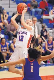  ?? JIM THOMPSON/JOURNAL ?? West Mesa’s Maiah Rivas, left, knocks over Marissa Weldon of Los Lunas on her way to the basket. Rivas was called for a charge but the Mustangs went on to win.