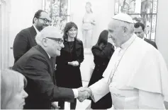  ??  ?? Pope Francis meets director Scorsese during a private audience at theVatican onWednesda­y. (Below) Pope Francis receives a gift from Scorsese. — Reuters photos