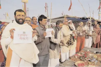  ?? — PTI ?? Devotees pray for the long life of Lance Naik Hanumantha­ppa Koppad, who is critical and on a ventilator at the Army R& R Hospital in New Delhi, on the bank of the Ganga in Allahabad on Wednesday.