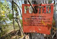  ?? A No Trespassin­g sign is seen April 20 on Medeiros’ property. ??