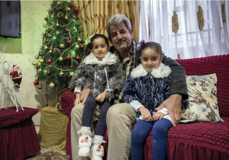  ?? Photos Campbell MacDiarmid for The National ?? Louis Khno, top, with his granddaugh­ters Alina, left, and Angelina; Sami Gergis Azo, 60, left; and shopping for decoration­s, below