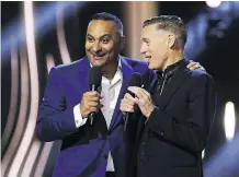  ?? LARS HAGBERG/AFP/GETTY IMAGES ?? Russell Peters, left, jokes with co-host Bryan Adams during the Juno Awards in Ottawa on Sunday night.