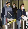  ?? MORGAN SETTE — THE ASSOCIATED PRESS ?? Spain’s Rafael Nadal, left, arrives at Adelaide Airport ahead of the Australian Open Thursday. Players will serve a 14-day quarantine period ahead of the Grand slam tournament which begins Feb. 8.