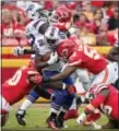  ?? ED ZURGA — THE ASSOCIATED PRESS ?? Buffalo Bills running back LeSean McCoy (25) is tackled by Kansas City Chiefs linebacker Reggie Ragland (59) while defensive lineman Rakeem Nunez-Roches (99) engages offensive guard Vladimir Ducasse (62) during the first half of an NFL football game in Kansas City, Mo., Sunday.