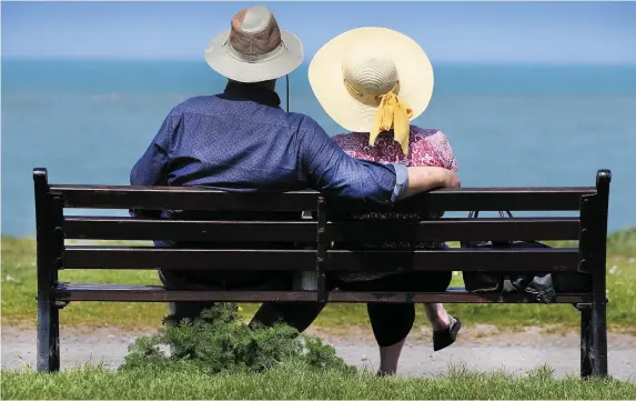  ??  ?? Barry and Lorna Grimes relax on a bench overlookin­g the sea while they enjoy the scorching weather in Skerries, Co Dublin, as the country is expected to bask in temperatur­es topping 26C today. However, there was tragedy on the fine day as an angler...