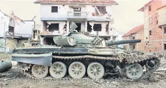  ?? ?? A Russian tank of the Yugoslav Army sits abandoned in the eastern Kosovar village of Klina after having been destroyed by Nato air strikes.
