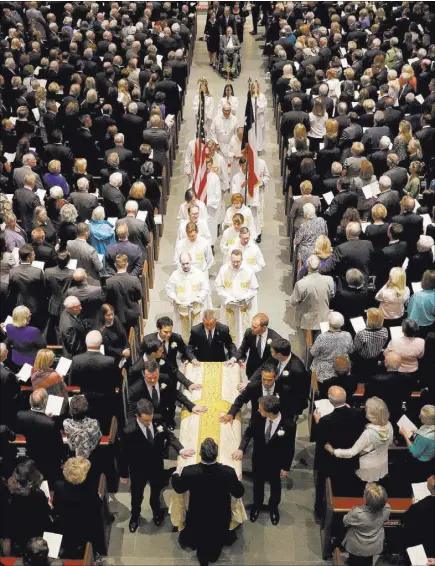  ?? David J. Phillip The Associated Press ?? The casket of former first lady Barbara Bush is carried down the aisle Saturday at St. Martin’s Episcopal Church in Houston. Roughly 1,500 people attended the invitation-only service.