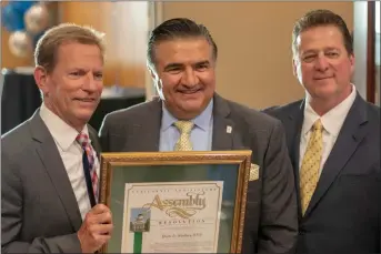  ?? Eddy Martinez/ For The Signal (See additional photos at signalscv.com) ?? Assemblyma­n Dante Acosta, middle, honors David Poole, left, and John Shaffery of Poole &amp; Shaffery LLP during a celebratio­n in recognitio­n of the law firm’s 20 years of service in Santa Clarita.