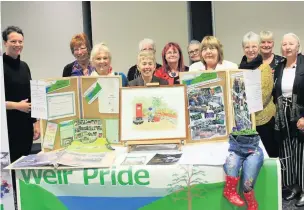  ??  ?? ●● Weir Pride members with their display