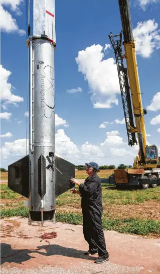  ?? Brett Coomer / Staff photograph­er ?? An Exos Aerospace rocket is moved into position for an engine test in July at the Caddo Mills Municipal Airport outside Dallas.