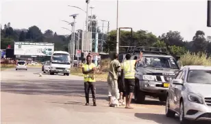  ?? ?? Unidentifi­ed youths ask for cash from motorists on the grounds that they are maintainin­g Churchill Road in Harare yesterday. — Picture Nicholas Bakili