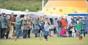  ??  ?? Games 8JP f32 Morar Above: Spectators cheer on some young runners.