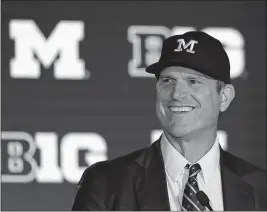  ?? [CHARLES REX ARBOGAST/THE ASSOCIATED PRESS] ?? Michigan coach Jim Harbaugh smiles while answering questions Friday during Big Ten media days in Chicago.