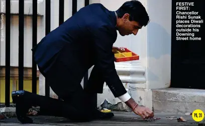  ??  ?? FESTIVE FIRST: Chancellor Rishi Sunak places Diwali decoration­s outside his Downing Street home