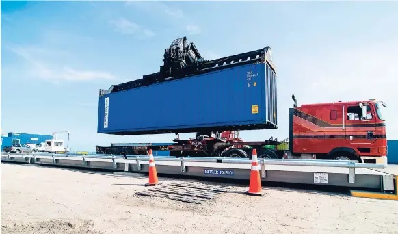  ??  ?? In this 2016 photo, a container is placed on the new weighbridg­e at the port terminal operated by Kingston Wharves Limited.