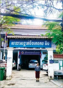  ?? SANGEETHA AMARTHALIN­GAM ?? BKK1 commune chief Prak Maly stands before her office, which was once a vice den. The 1940s building has stood the test of time in an everchangi­ng BKK1.