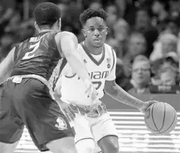  ?? WILFREDO LEE/ASSOCIATED PRESS ?? Miami guard Chris Lykes, right, looks for an open teammate under pressure from Florida State guard CJ Walker Sunday. The Hurricanes defeated the Seminoles.