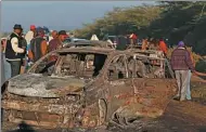  ?? THOMAS MUKOYA / REUTERS ?? People look at the wreckage of cars burnt after a fireball from a tanker engulfed several vehicles and killed several people, near Naivasha, Kenya, on Sunday.