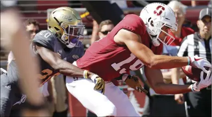  ??  ?? Stanford wide receiver JJ Arcega-Whiteside (19) catches a touchdown pass over UC Davis defensive back Vincent White (20) in the first half in an NCAA college football game in Stanford, on Saturday. AP PHOTO/JIM GENSHEIMER