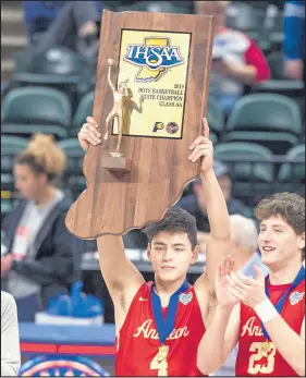  ?? DOUG MCSCHOOLER/POST-TRIBUNE ?? Andrean’s John Carrothers (4) celebrates with the trophy after the 59ers won the Class 2A title at Bankers Life Fieldhouse on Saturday.