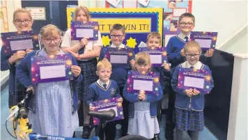  ??  ?? 100pc attendance winners at St Paul’s primary school in Oswaldtwis­tle