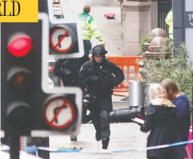  ?? ROBERT PERRY / AFP VIA GETTY IMAGES ?? Police respond at the scene of a knife rampage at the Park Inn Hotel in central Glasgow, Scotland on Friday. Armed officers shot dead an asylum seeker from Sudan suspected of injuring six people in the stabbing spree.