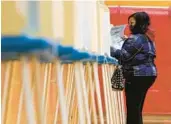  ?? MORRY GASH/AP ?? A voter casts a ballot on Nov. 3, 2020, at Marshall High School in Milwaukee. Then-President Donald Trump lost the state by nearly 21,000 votes to Democrat Joe Biden.