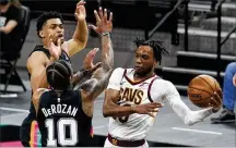  ?? ERIC GAY / AP ?? Cleveland Cavaliers guard Darius Garland (right) drives to the basket against San Antonio Spurs forward DeMar DeRozan (10) during Monday’s game in San Antonio. Garland scored 37 points.