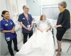  ?? — Reuters ?? Britain’s Prime Minister Theresa May speaks to patient Sandra Dunn as she visits Frimley Park Hospital near Camberley on Thursday.