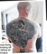  ??  ?? Brian Kirby showing off a tattoo on his back