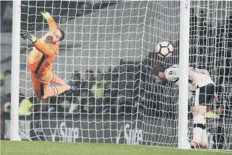  ??  ?? Derby defender Jacob Butterfiel­d inexplicab­ly ducks under the ball as Wes Morgan’s 87th-minute header rescues an FA Cup replay for Leicester