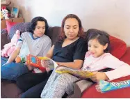  ?? DON USNER/SEARCHLIGH­T NEW MEXICO ?? Nayeli Saenz and her son Steven look on as Anabell, 6, reads a book at their Las Cruces home. Saenz, 34, who was a brought illegally from Mexico as a 9-year-old, graduated high school, got married, got divorced, and raised her children in Las Cruces.