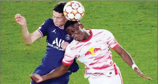  ?? ?? PSG’s Julian Draxler (left), and Leipzig’s Ilaix Moriba challenges for the ball during their Champions League soccer match between Paris Saint Germain and RB Leipzig at the Parc des Princes stadium in Paris. (AP)