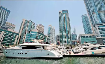  ?? — AFP ?? Luxury yachts are moored at the Dubai Marina Beach in the Gulf emirate. Charter companies said they have seen an increased interest in yachting after Coronaviru­s measures eased, especially among those who want to spend time with friends and family.