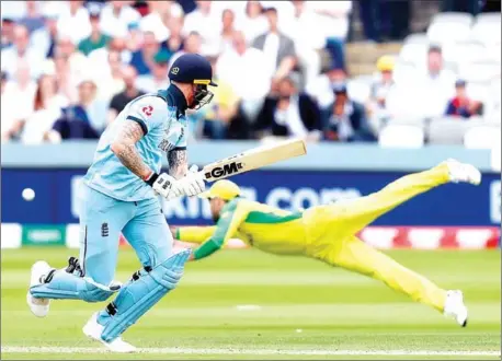  ?? ADRIAN DENNIS/AFP ?? England’s Ben Stokes runs between the wickets after playing a shot past Australia’s diving Glenn Maxwell during the 2019 Cricket World Cup group stage match between England and Australia at Lord’s Cricket Ground in London on June 25.