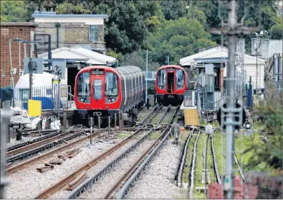  ?? AP PHOTO ?? A police forensic tent stands setup on the platform next to the train, at left, on which a homemade bomb exploded at Parsons Green subway station in London, England, Friday.