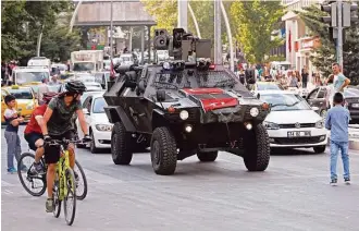  ?? Burhan Ozbilici / Associated Press ?? Some Muslim faithful in Ankara, Turkey, where a police vehicle patrols, welcomed a state of emergency on Friday, giving President Recep Tayyip Erdogan sweeping powers in ruling the country.