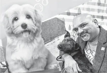  ?? Billy Calzada/Staff photograph­er ?? Deven Bhakta, owner of Dogtopia, enjoys a moment with his dog, Kallie, at the dog day care.