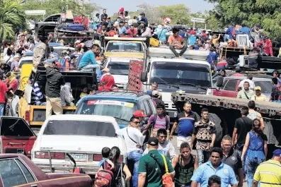  ?? PHOTO: REUTERS ?? Fleeing hardship . . . Venezuelan­s line up to cross into Colombia at the border in Paraguacho­n, Colombia.